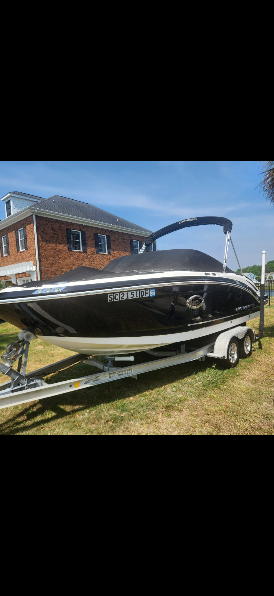 Chaparral boat with a glossy dark hull after detailing